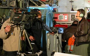 A Film crew interviews the Tactical Commander in front of the radar displays during iceberg reconnaissance in 2005